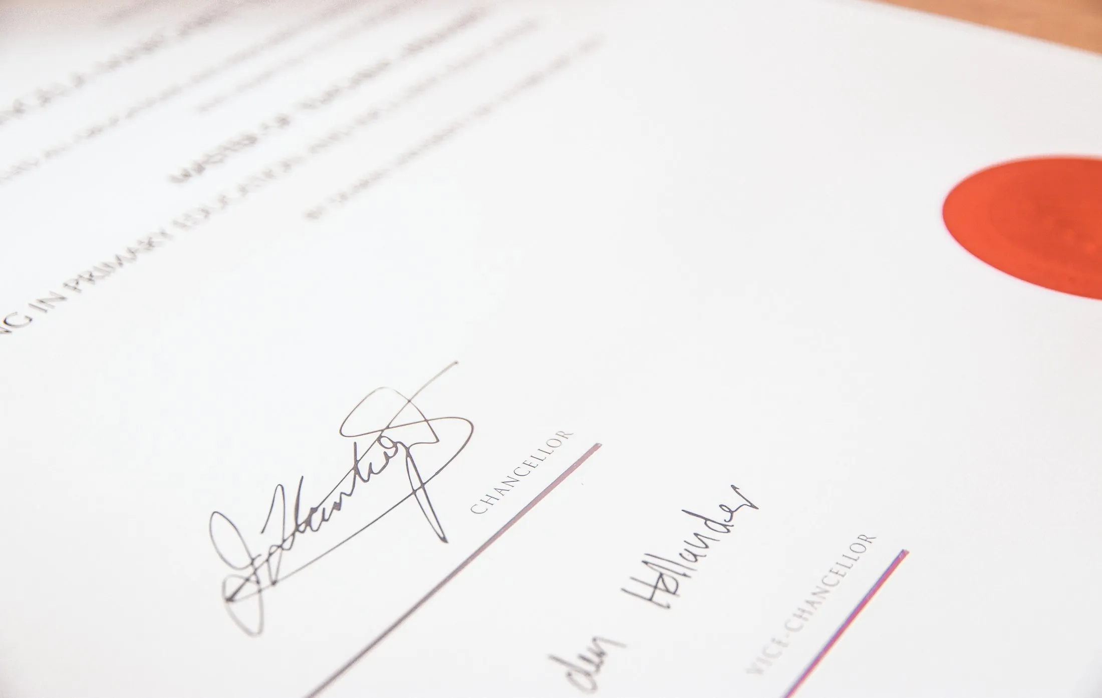 A degree certificate with a red seal and signatures
