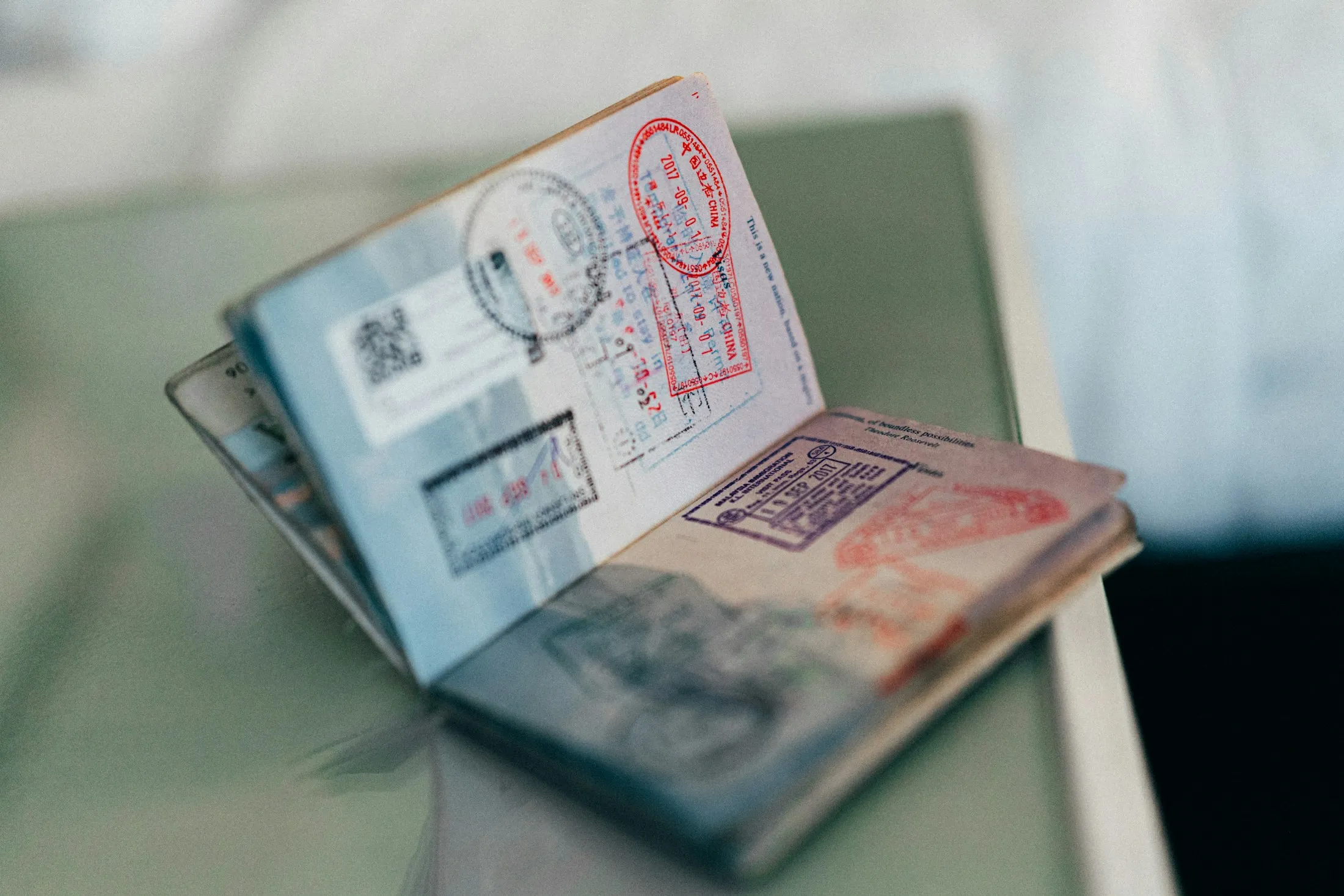 An open passport with visa stamps