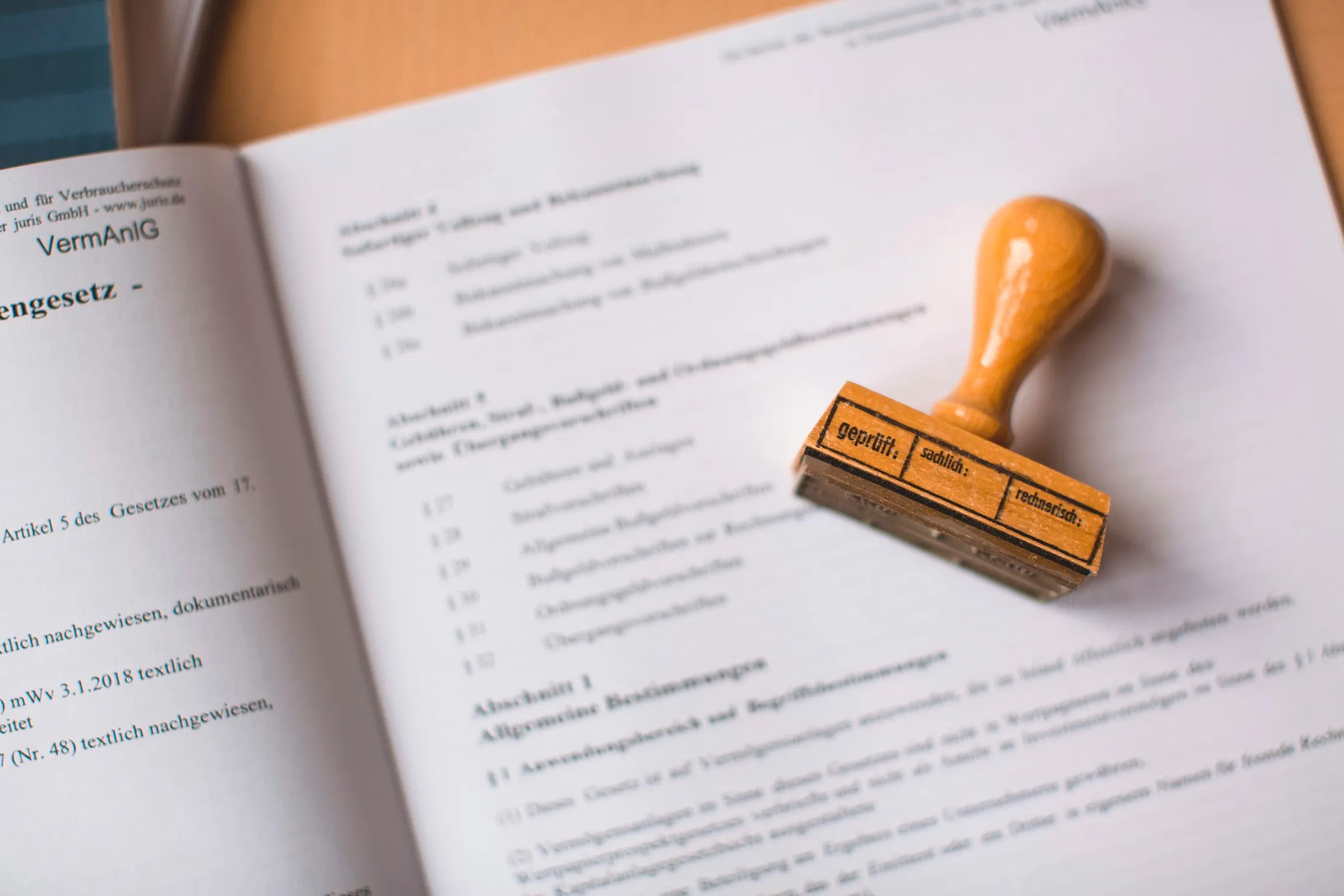 A wooden rubber stamp resting on an open legal document